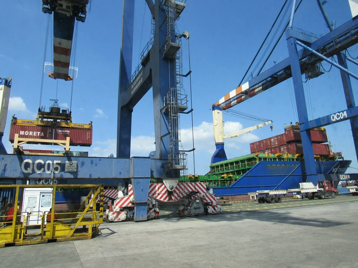 Port crane loading containers onto a cargo ship
